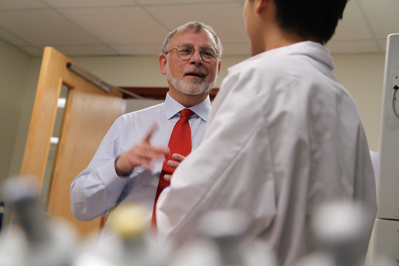 A mentor talking with a mentee in a classroom.