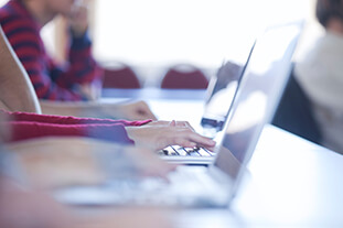 Typing on a computer.